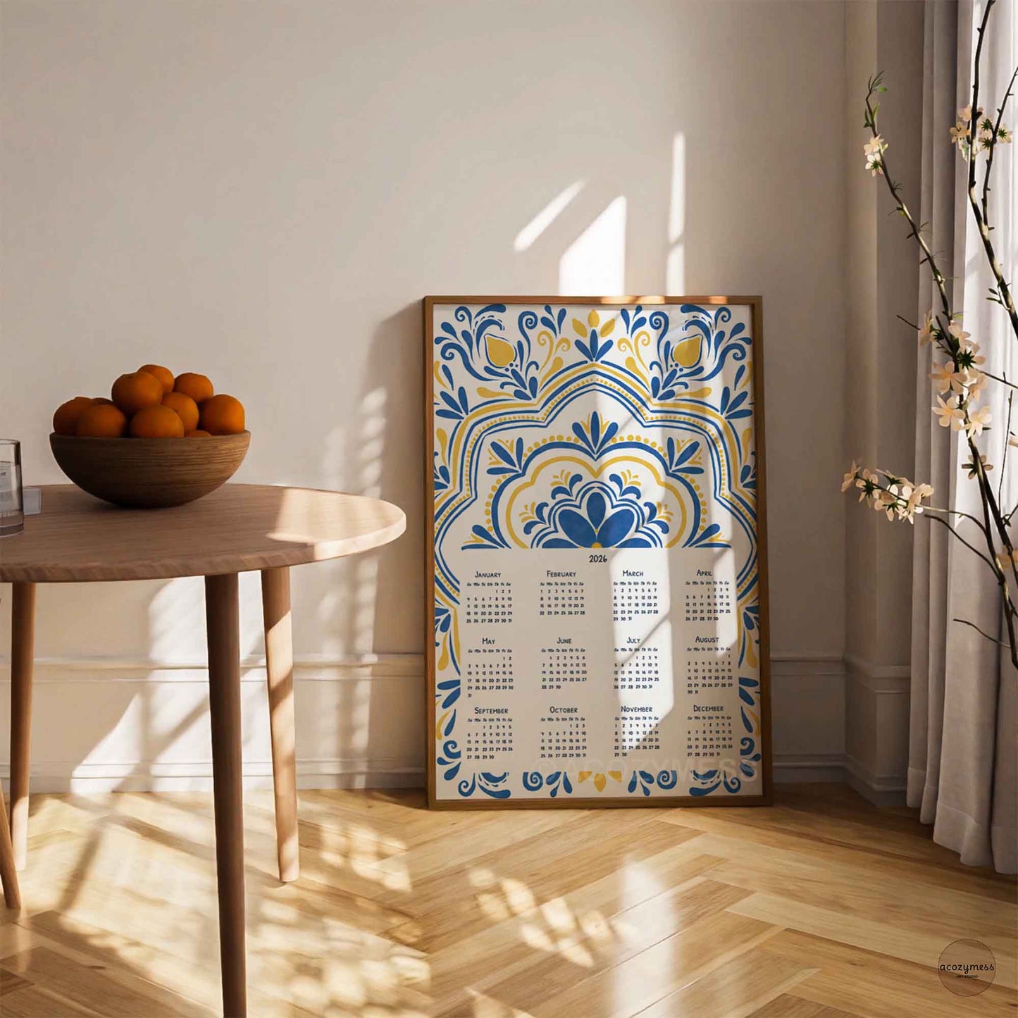 Decorative calendar with blue and yellow pattern displayed in wood frame in dining room decor.