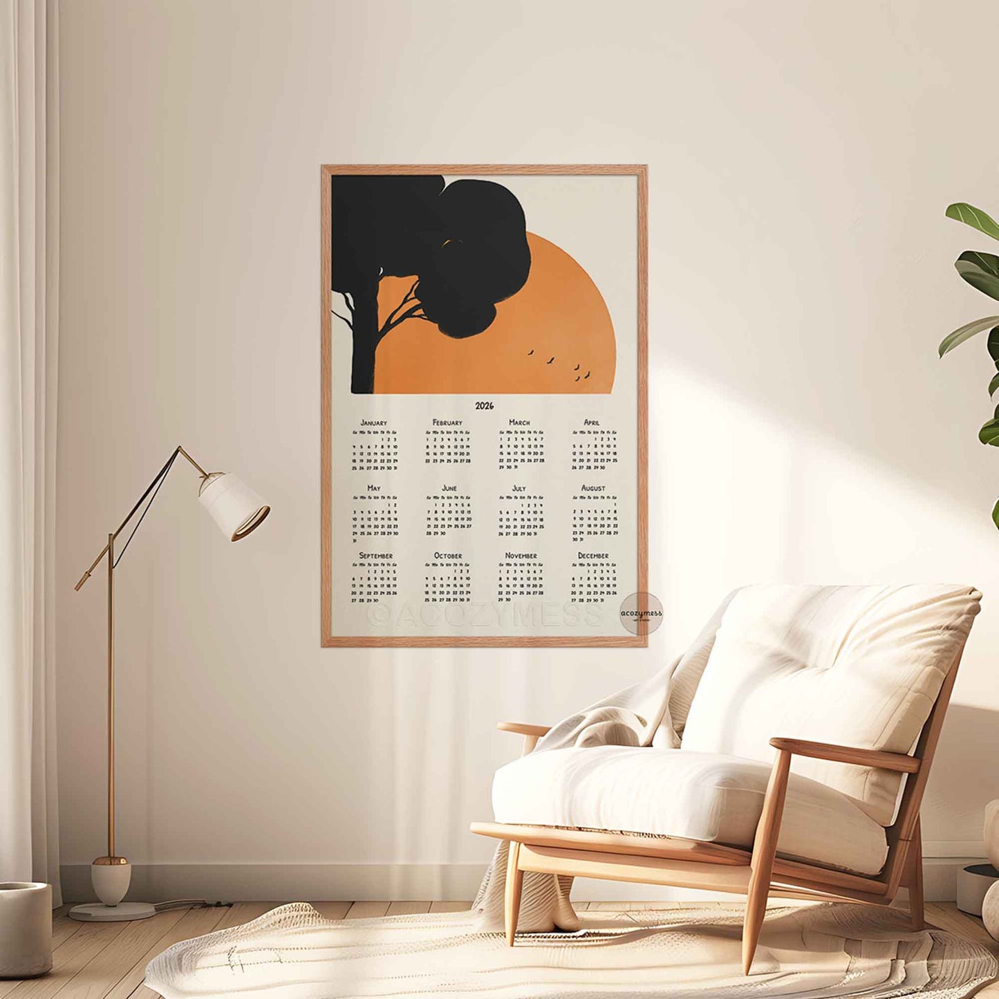 Calendar poster with a decorative design of a tree and sun in a living room setting .