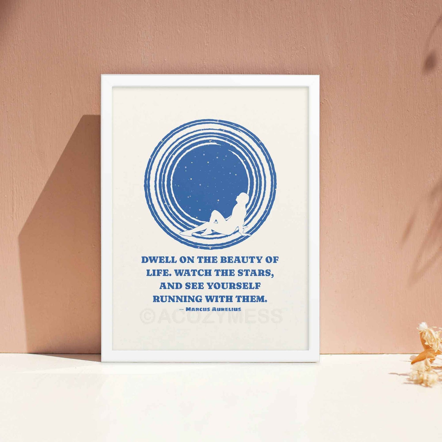 Marcus Aurelius poster with quote on beauty of life with an illustration of star gazing in blue and white colors, in white frame.