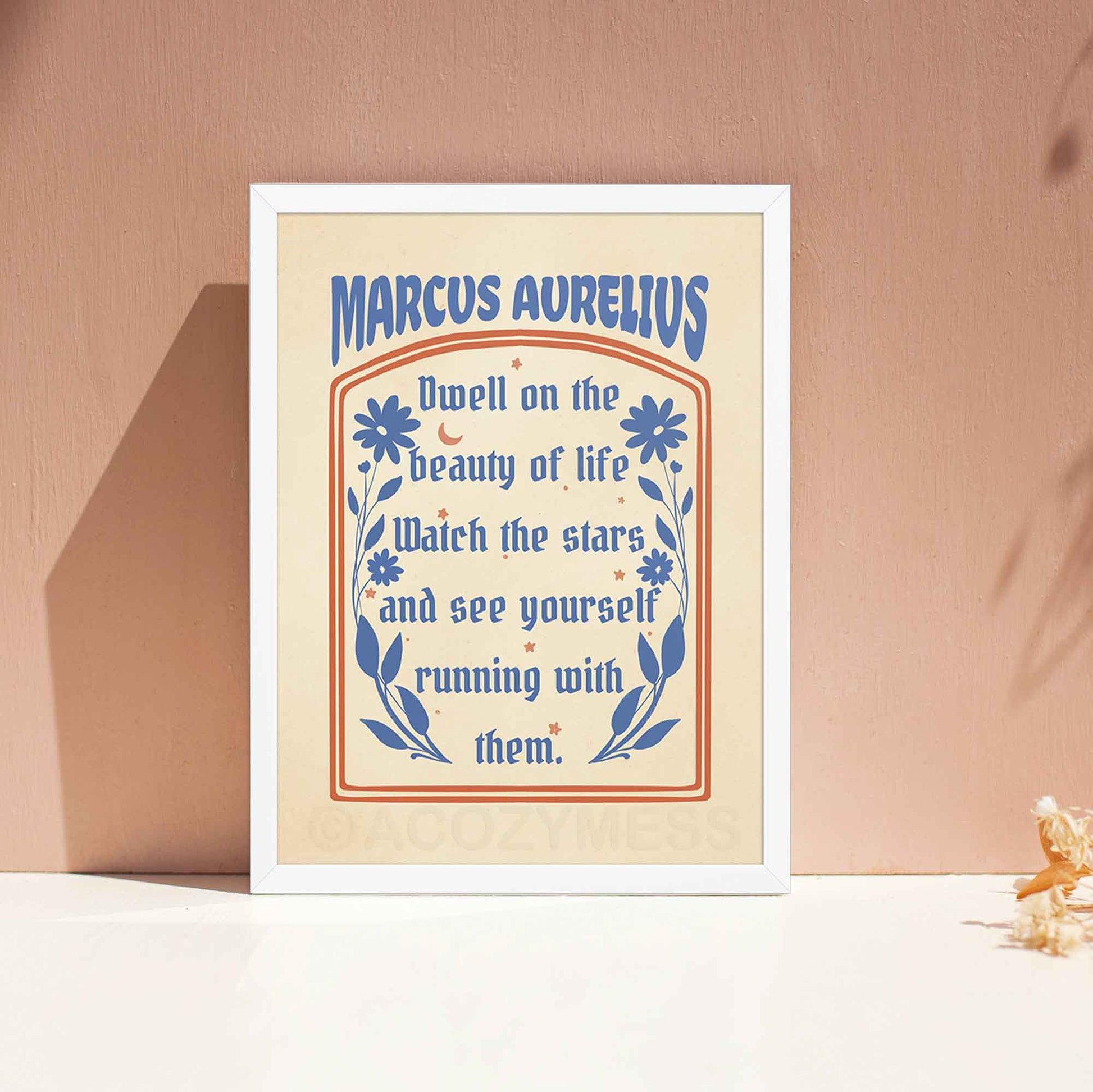 Stoic poster displayed in white frame featuring the Marcus Aurelius quote, "Dwell on the beauty of life," in elegant typography.