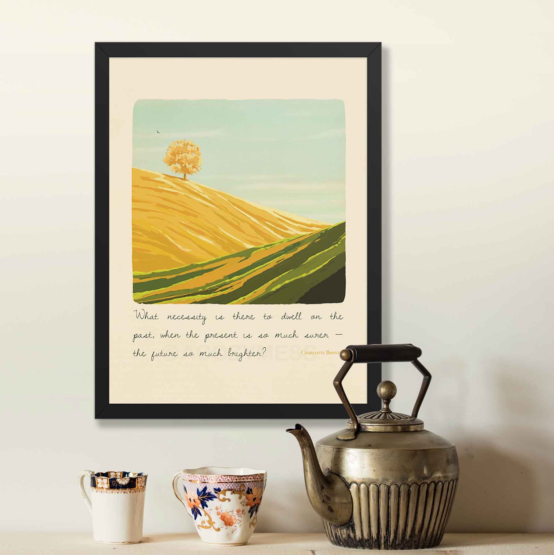 A landscape wall art print featuring a motivating quote by Charlotte Brontë, the artwork includes a peaceful illustration of a bright mountain landscape, symbolizing optimism, growth, and a forward-looking mindset, displayed in black frame.