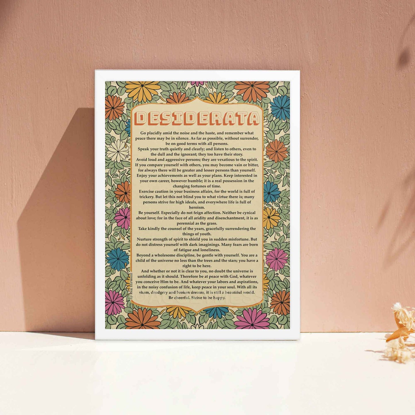 Desiderata poem poster with floral design in soothing colors of sage green, beige, orange and yellow displayed in white frame