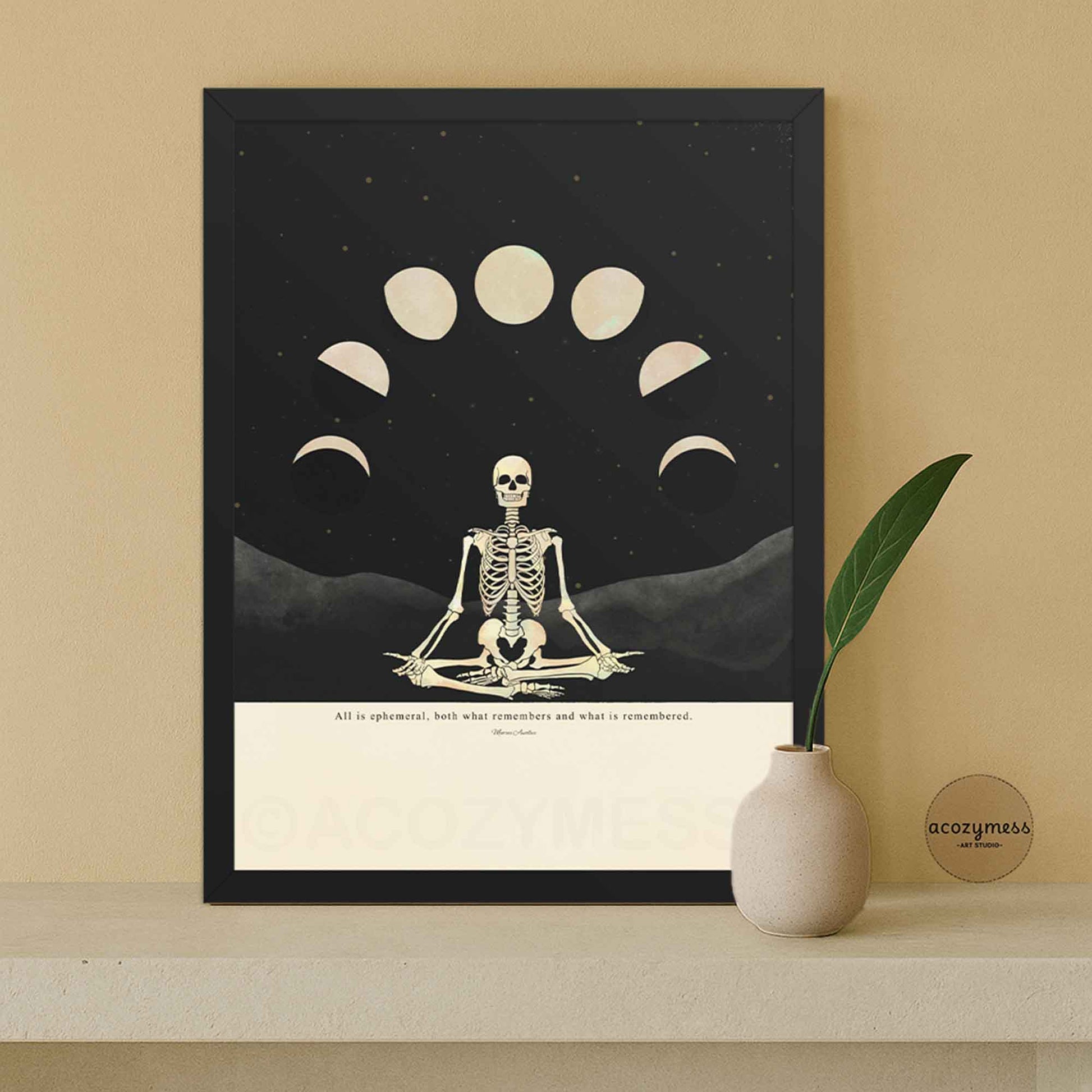 Marcus Aurelius quote poster with skeleton and moon phase illustration, printed on beige background and displayed in sleek black wooden frame, ready to hang philosophy wall art