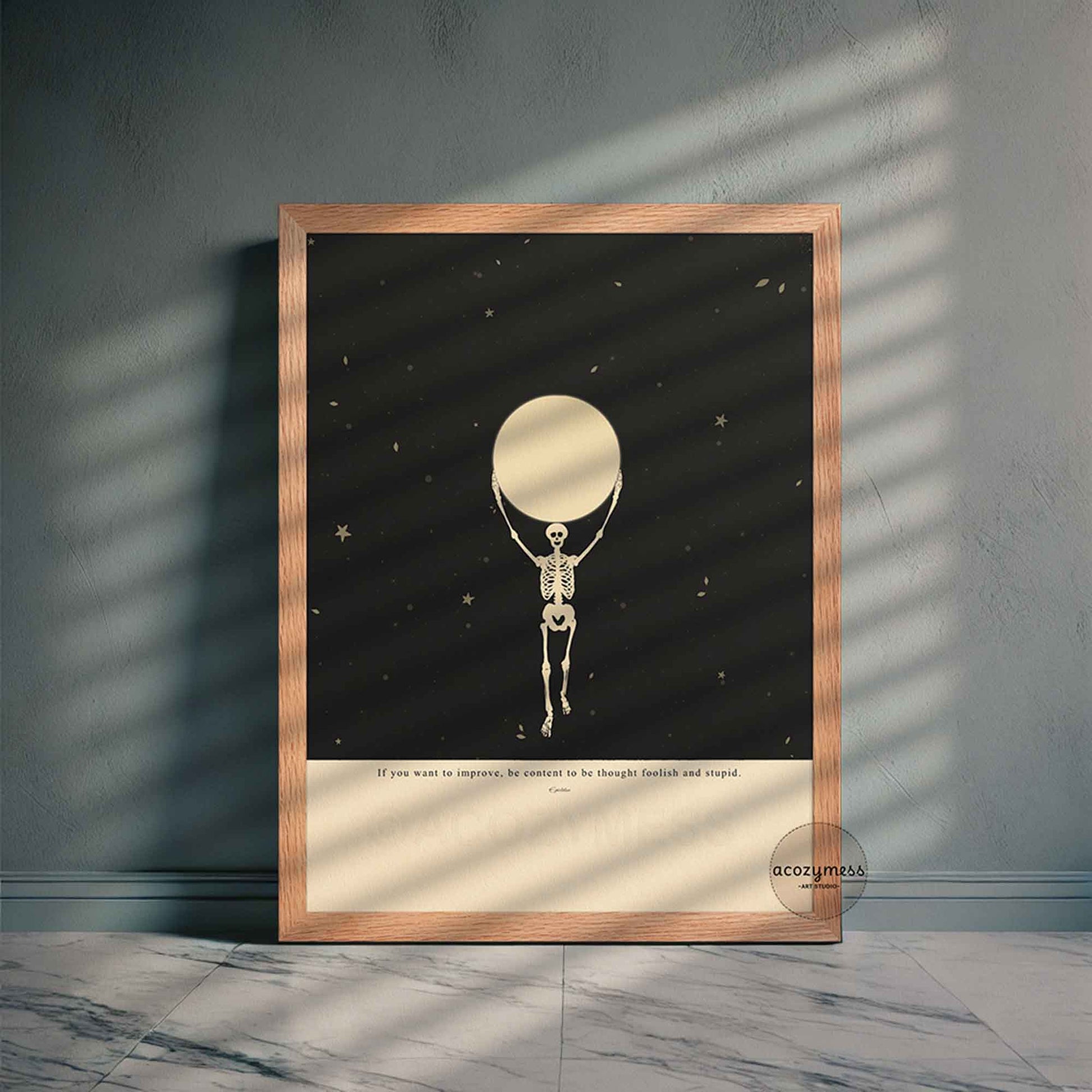 Oak-framed stoic poster with Epictetus saying and a symbolic skeleton and moon design over a beige and black starry background, printed for moody meaningful decor.