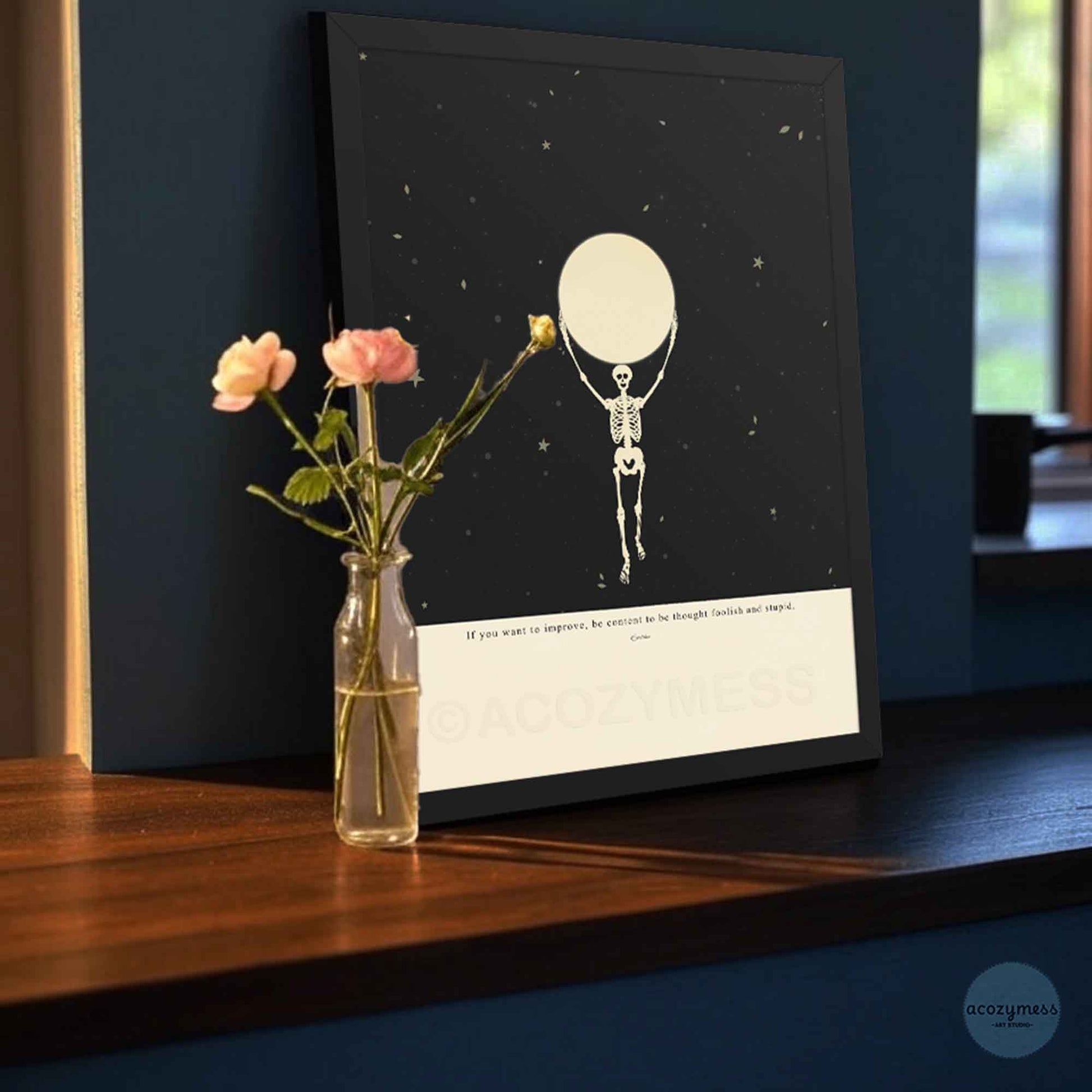 Black Framed Epictetus poster with skeleton holding the moon illustration on a starry black and beige background