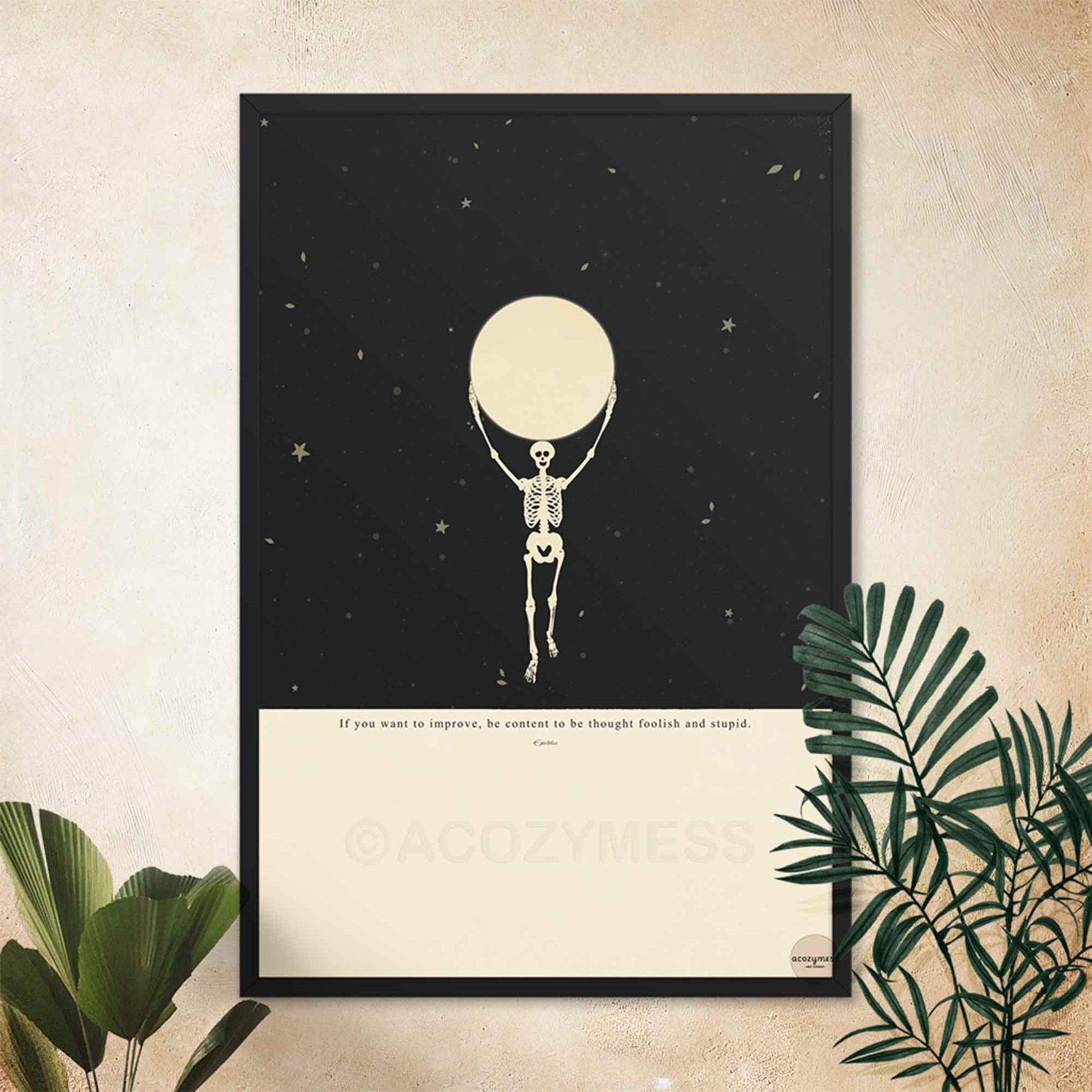 Framed Epictetusquote with skeleton holding the moon illustration in a modern black wood frame.
