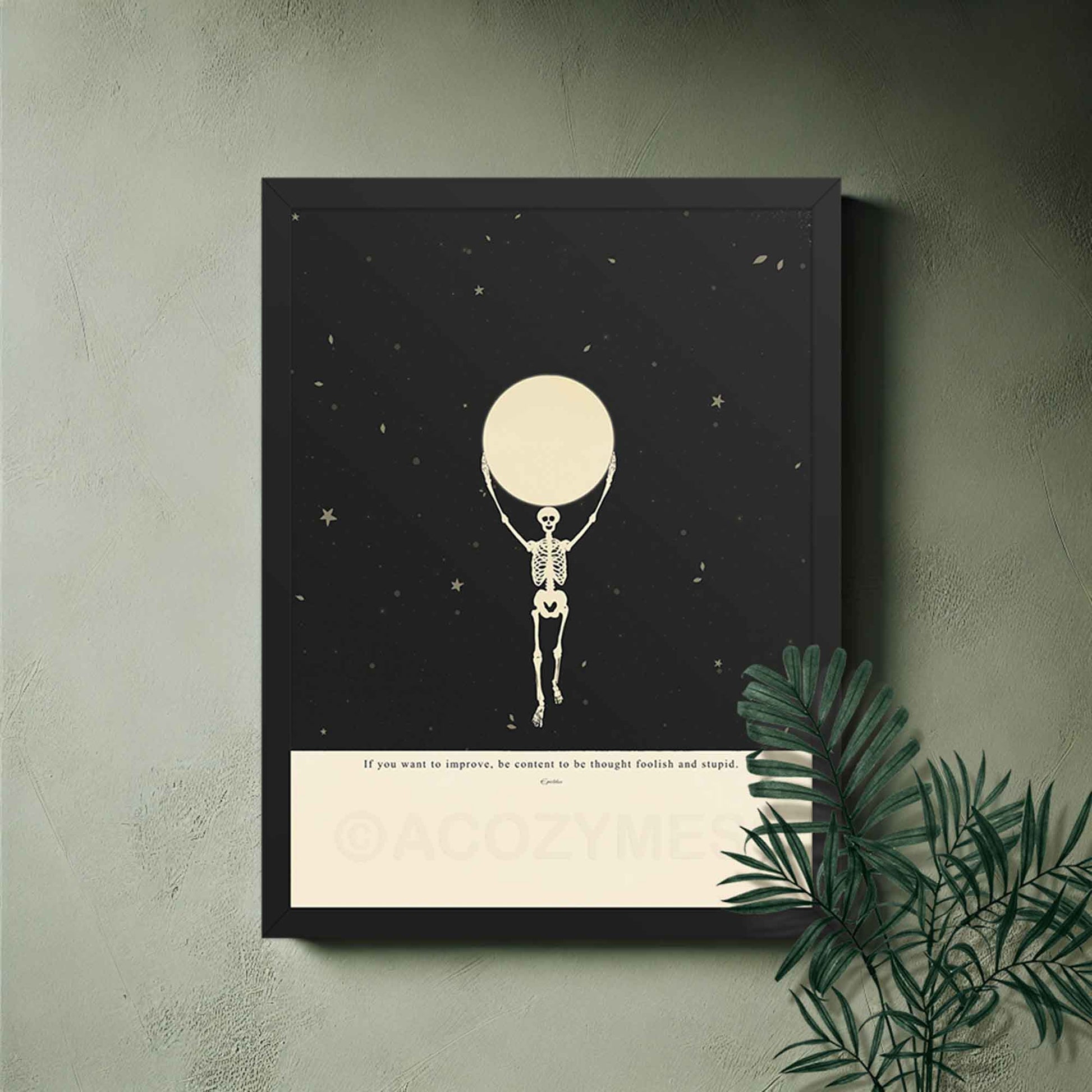 Framed artwork of a skeleton holding a moon against a starry night sky.