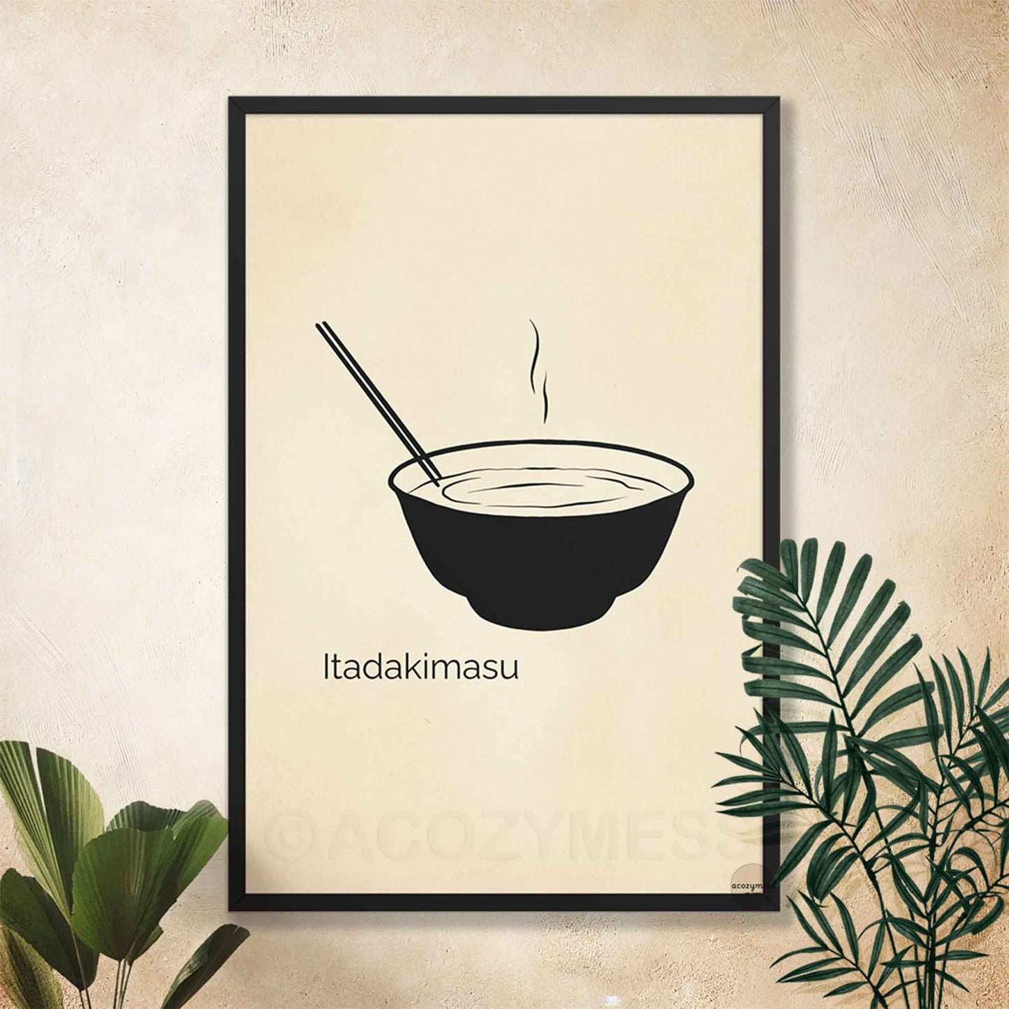 Framed artwork of a bowl with chopsticks and 'Itadakimasu' text on a beige wall.
