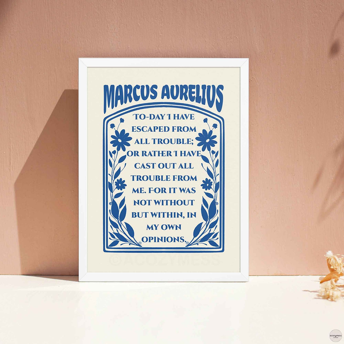 Marcus Aurelius Poster dark blue on cream with floral design, in white frame.