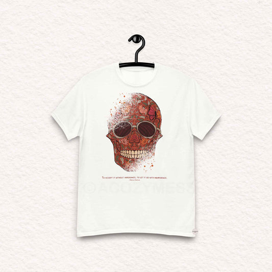 A white  Tshirt featuring a detailed skull and floral design, paired with a Marcus Aurelius quote: "To accept it without arrogance, to let it go with indifference." The artwork symbolizes memento mori and Stoic philosophy, blending mortality with beauty.