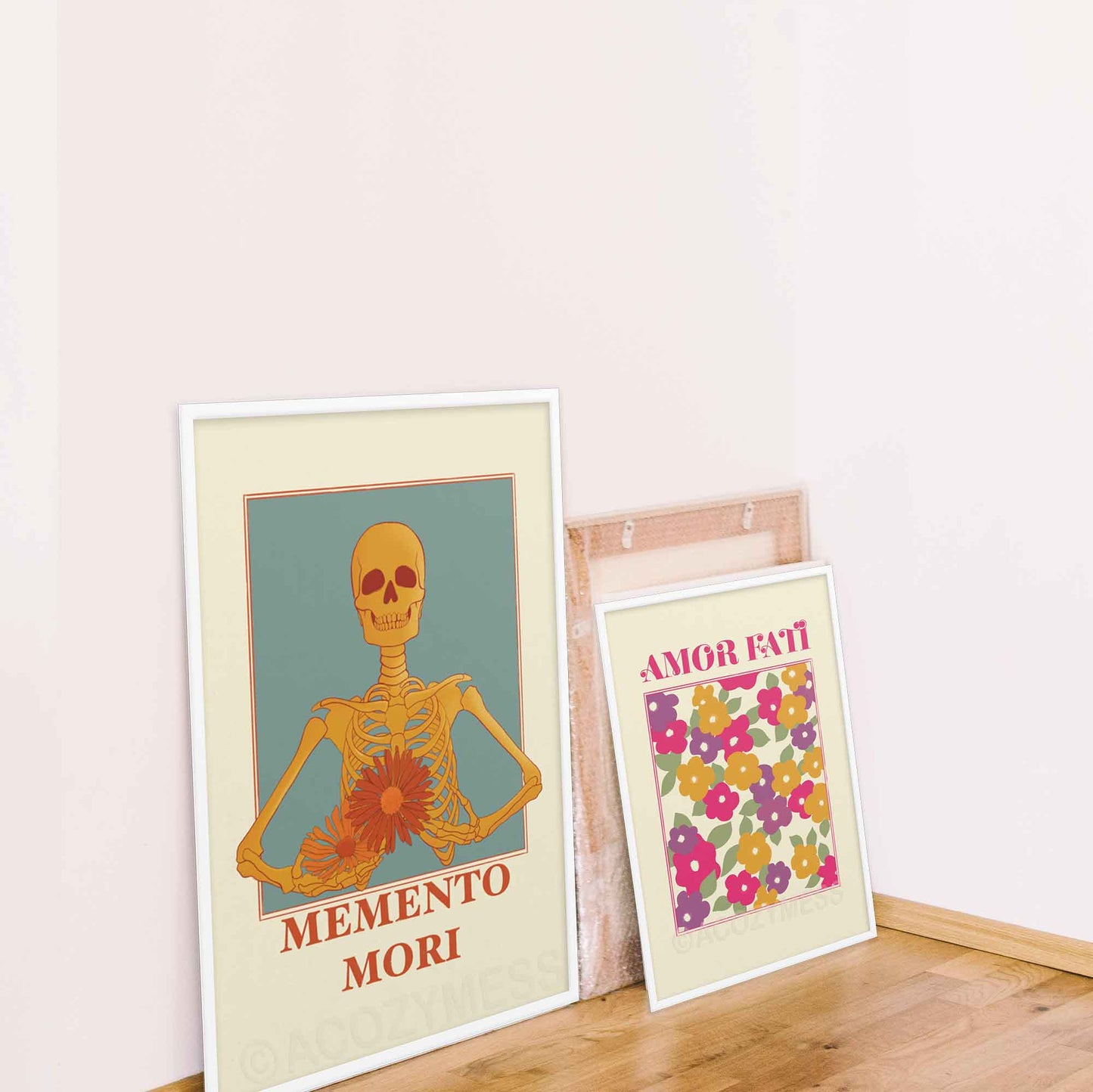 A memento mori art piece in beige blue, yellow & orange hues, featuring a skeleton carrying colorful flowers and amor fati poster, in white frames