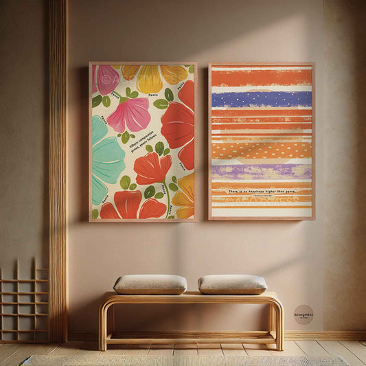 Two colorful framed artworks on a wall with quotes on compassion, peace and happiness.