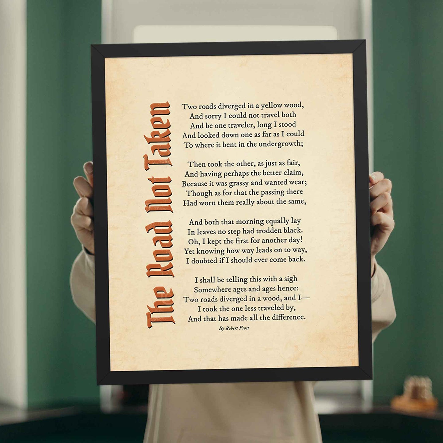 A vintage-style poem print featuring Robert Frost’s classic poem, The Road Not Taken printed on an aged, old-paper background, in black frame.