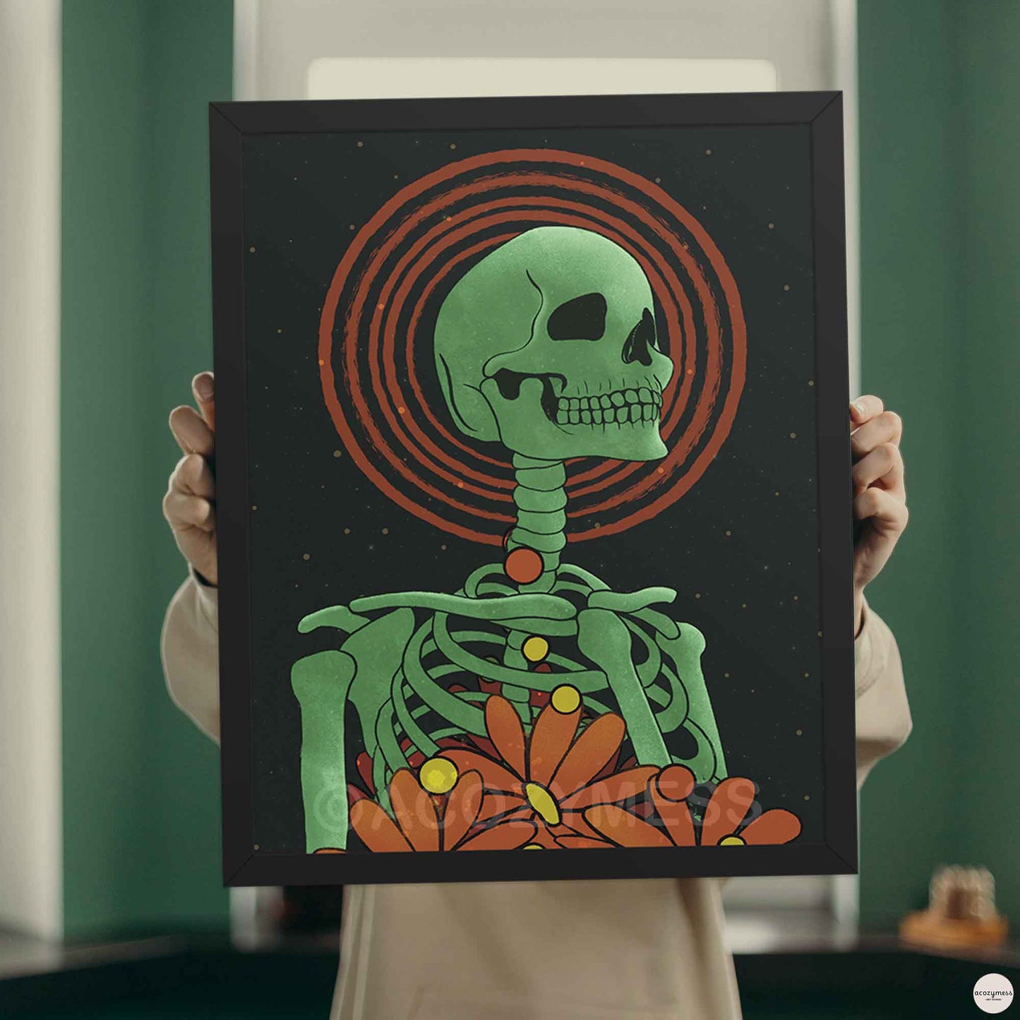 skeleton with florals in black frame in green, orange, contrasting beautifully against the star-speckled background.