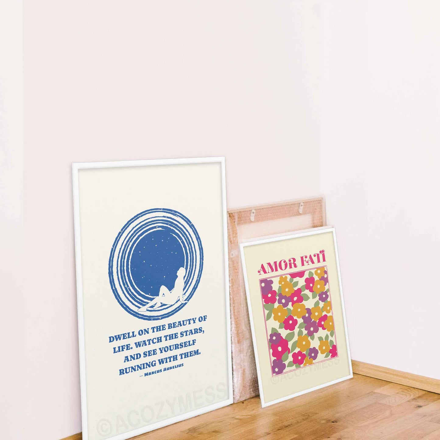 Marcus Aurelius poster with quote on beauty of life with an illustration of star gazing in blue and white colors, in white frame. and amor fati poster with abstract floral design in white frame
