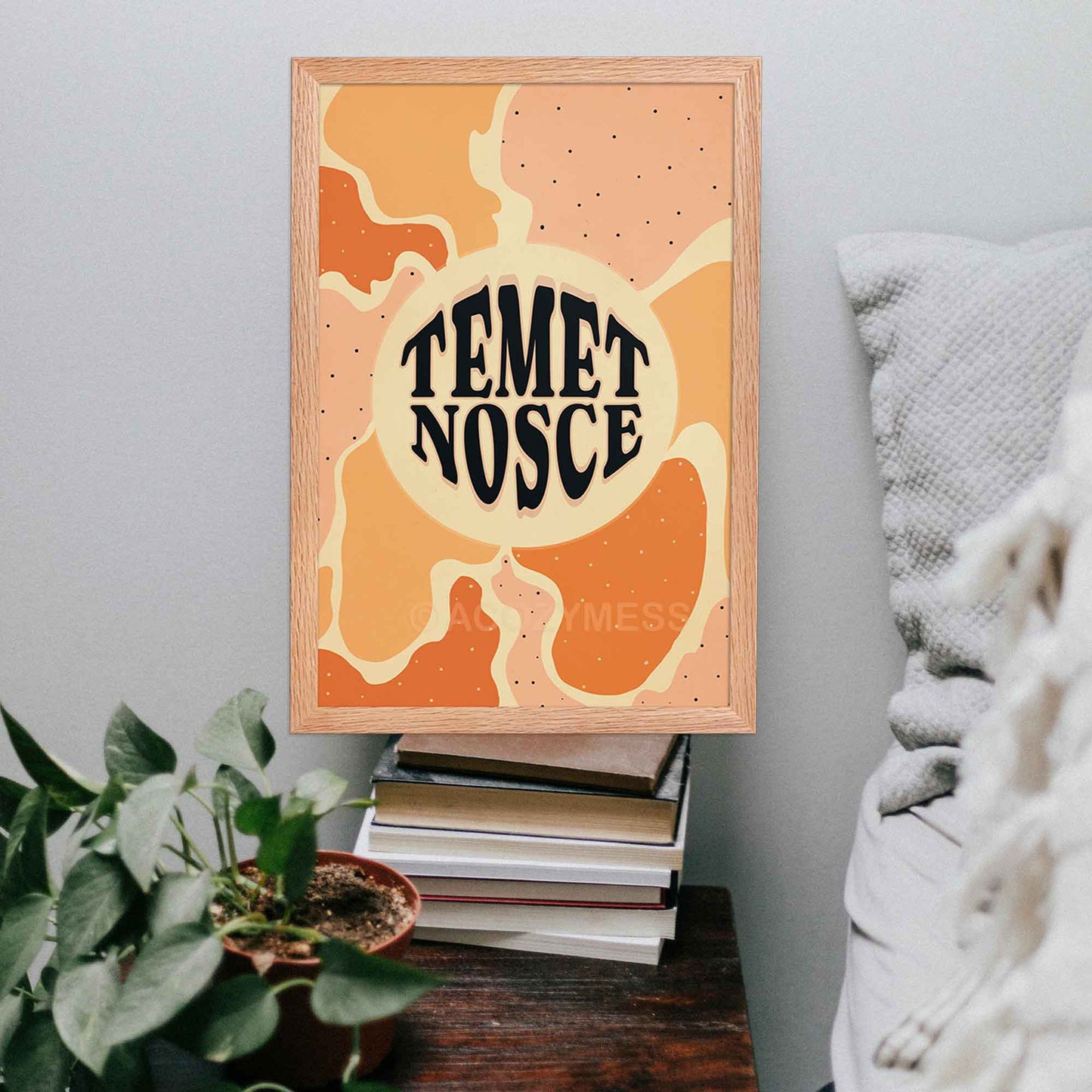 Temet nosce (know thyself) typography poster with abstract artwork in beige, yellow, orange and pink displayed in oakwood frame.