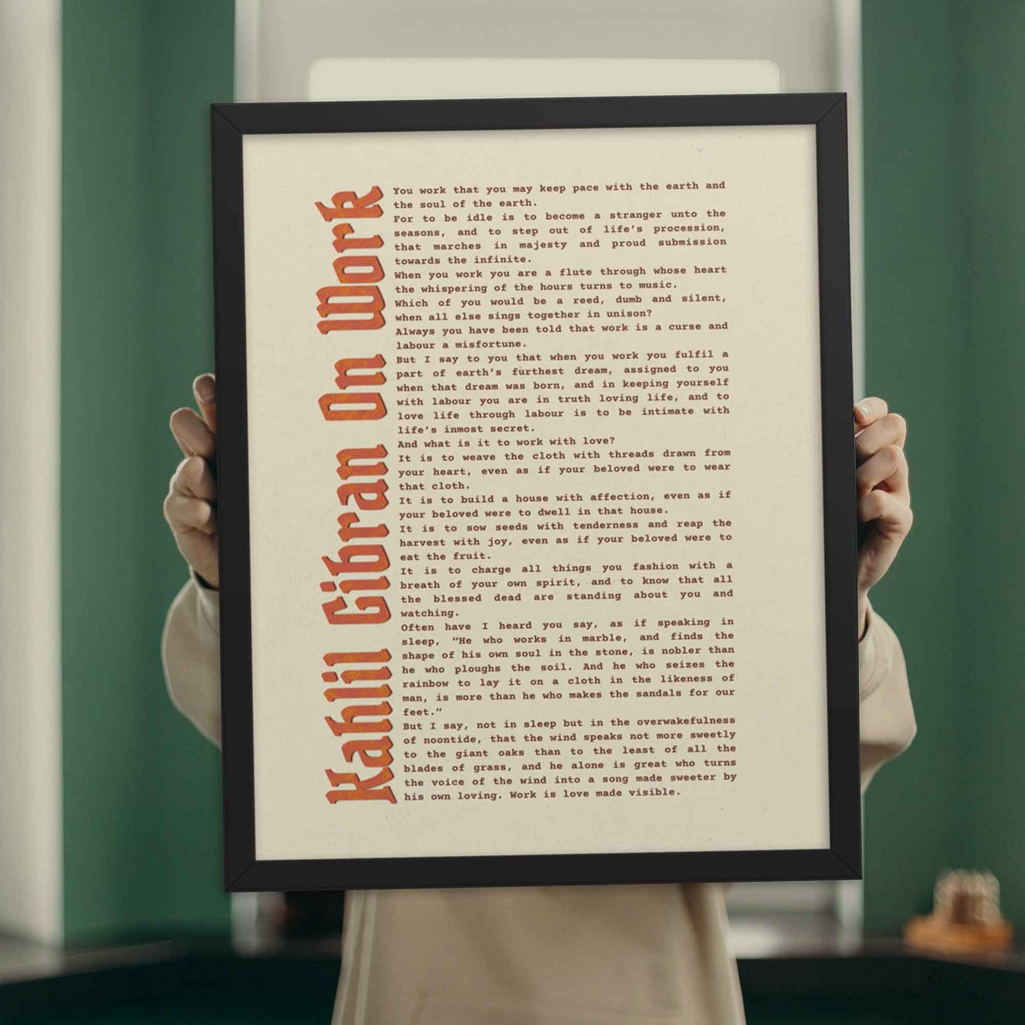 Work motivational poster by Kahlil Gibran in black frame.