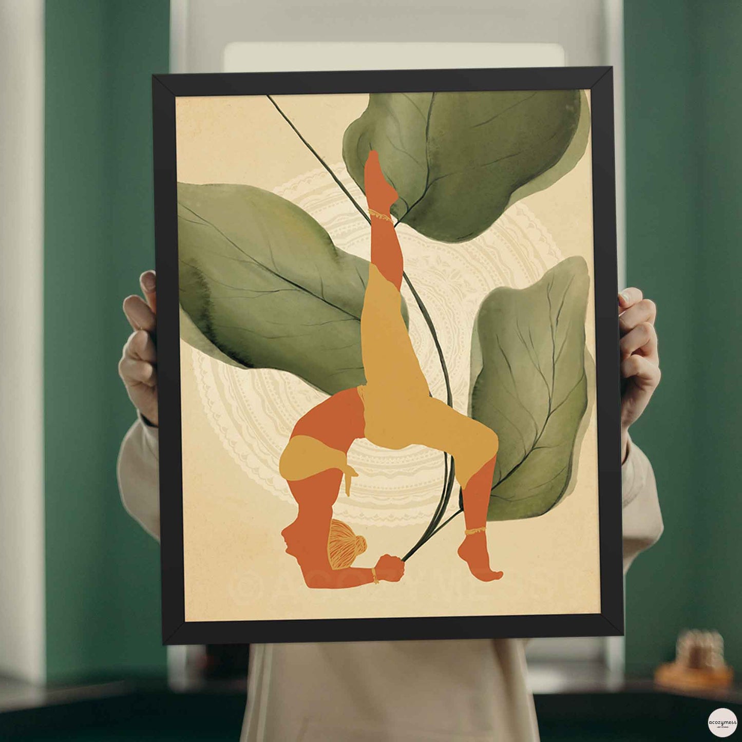 A black-framed poster featuring an illustration of a woman in a yoga pose, set against a backdrop of large leafy plants and mandala art in earthy tones for calming corner decor.