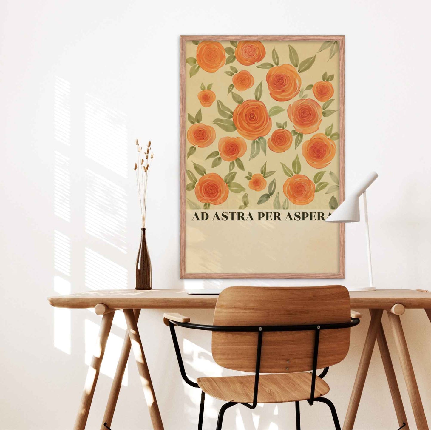 Latin phrase poster featuring an inspiring Latin phrase, Ad Astra Per Aspera, with elegant floral art, in oakwood frame on a desk wall.
