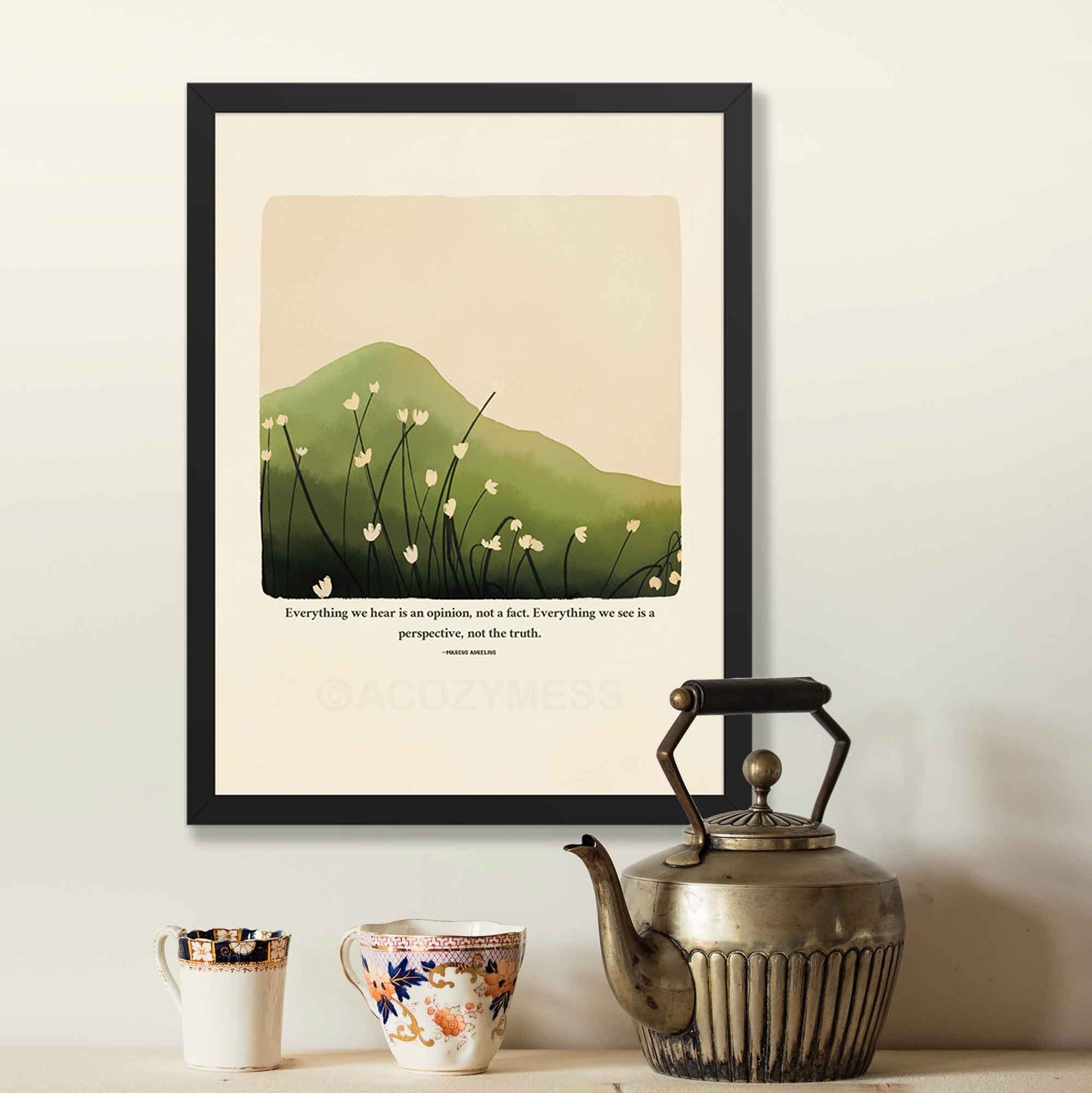 A stoic poster in black frame featuring Marcus Aurelius' quote, "Everything we hear is an opinion, not a fact. Everything we see is a perspective, not the truth," along with a serene nature illustration of a green hill or mountain with delicate white flowers.