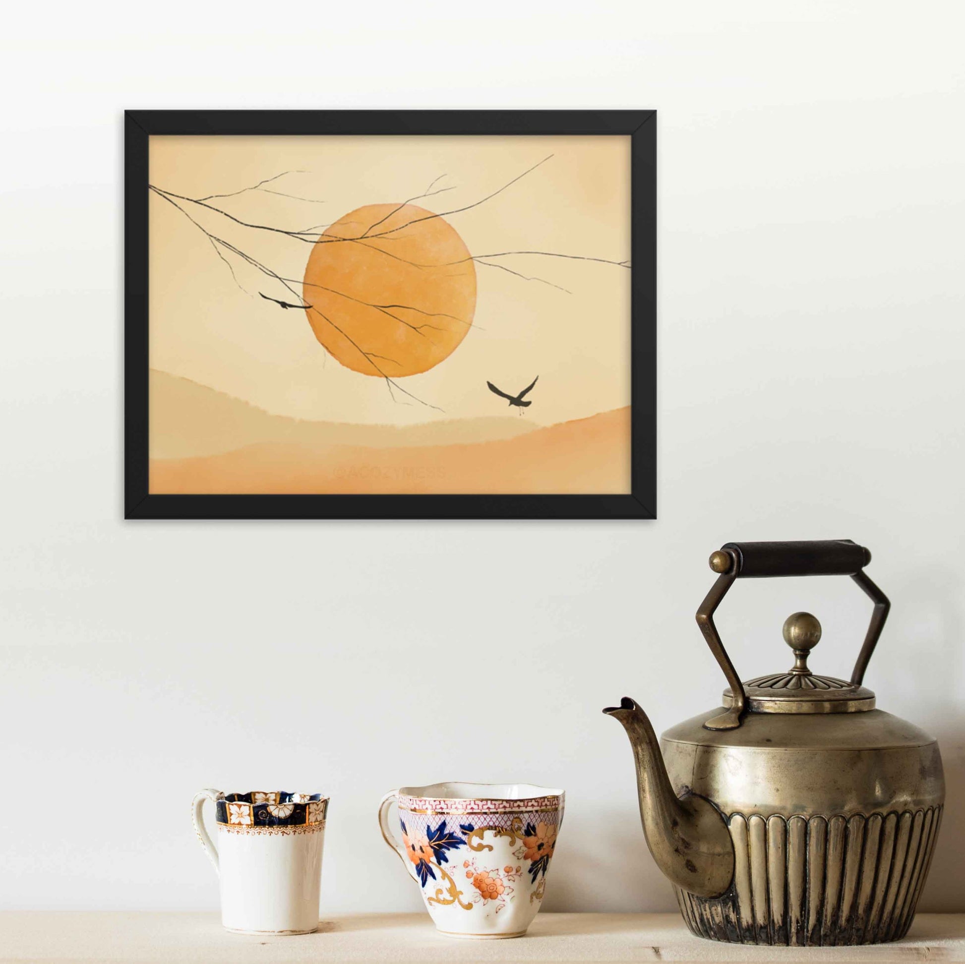 "Art print featuring a sun and flying birds in a muted yellow palette, framed in black