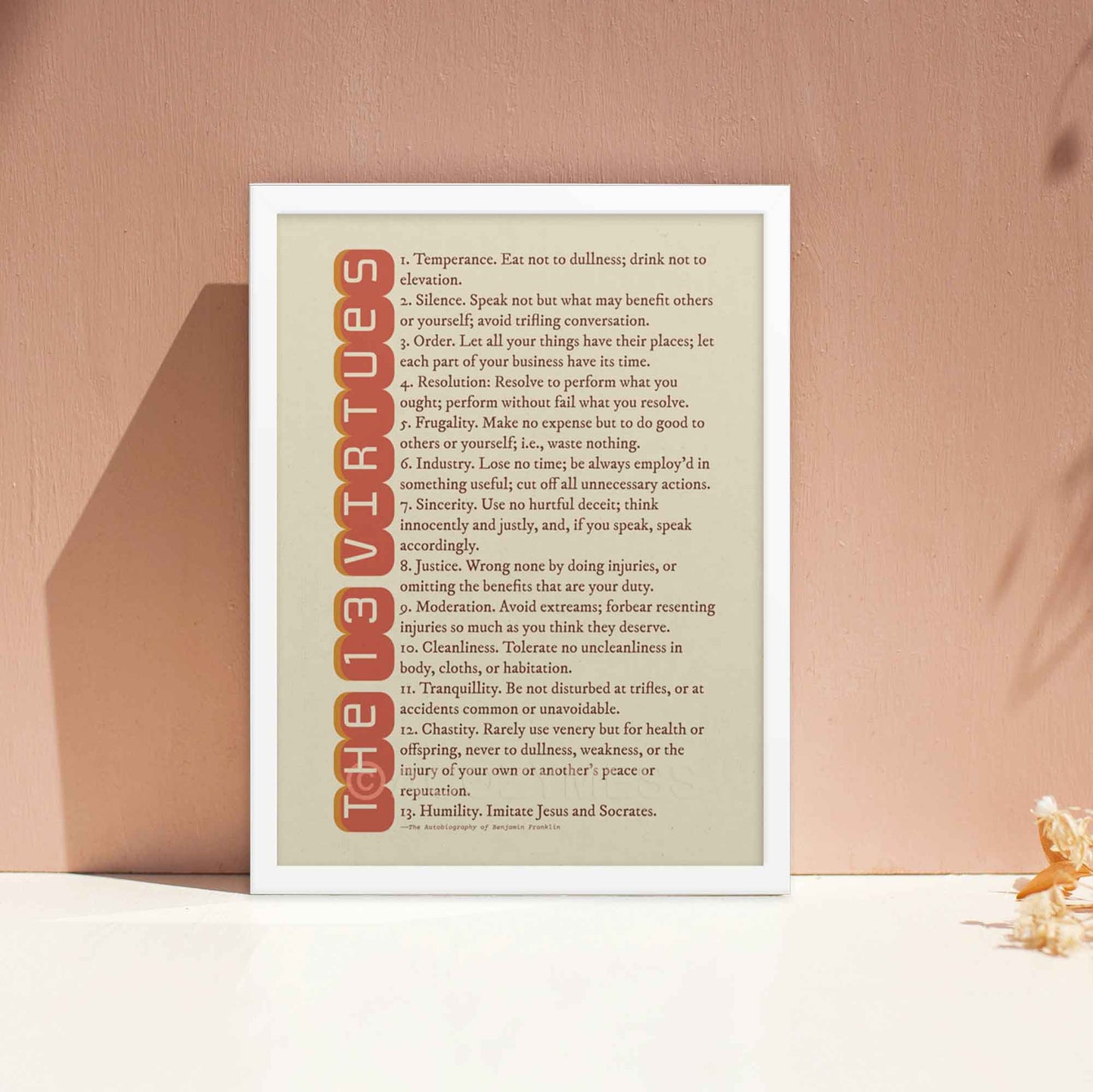 13 Virtues by Benjamin Franklin poster in red on beige, displayed in a white frame, perfect as inspirational gift and personal growth.