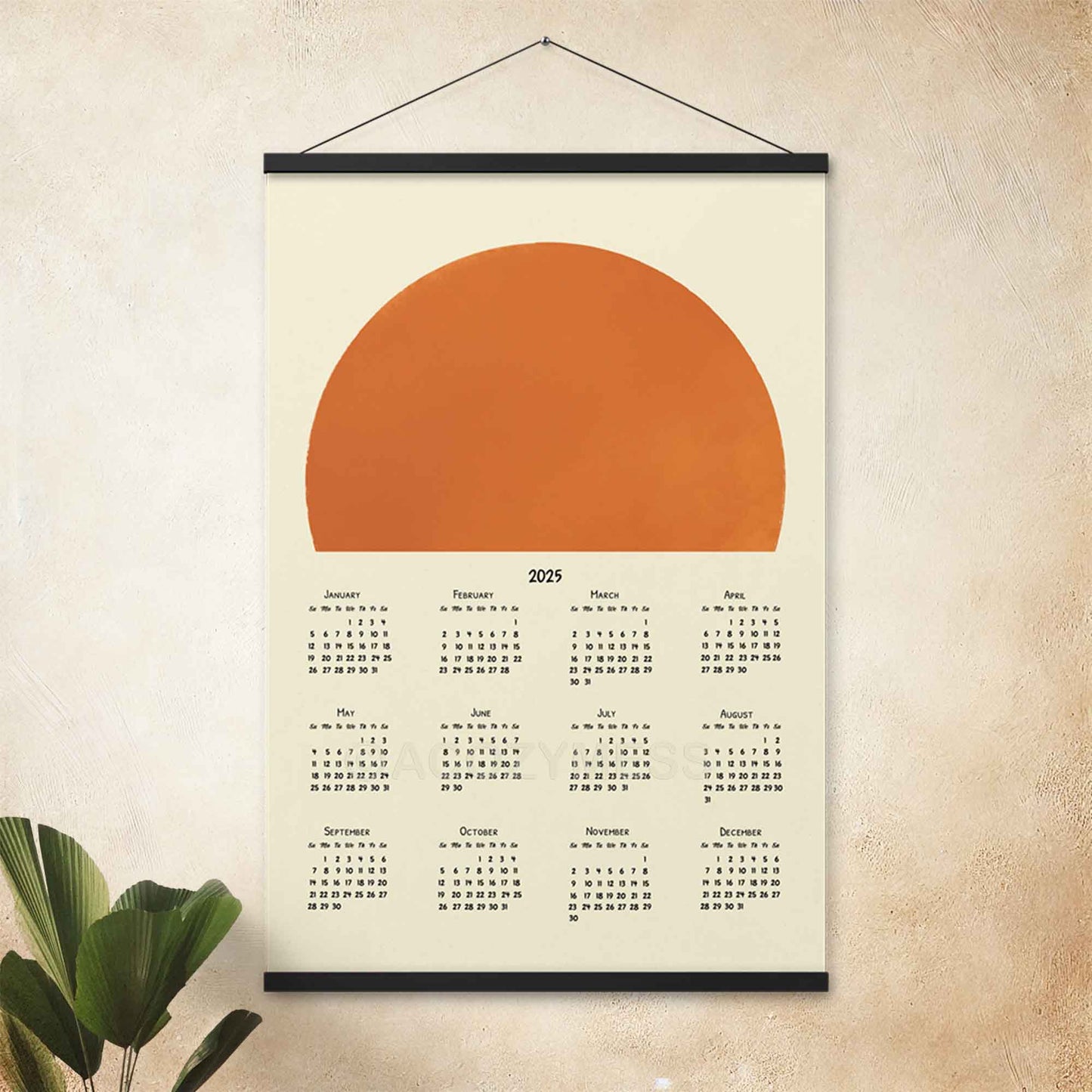 2025 yearly calendar poster with a minimalist sun design, with an black hanger, adding positivity and warmth to your decor.