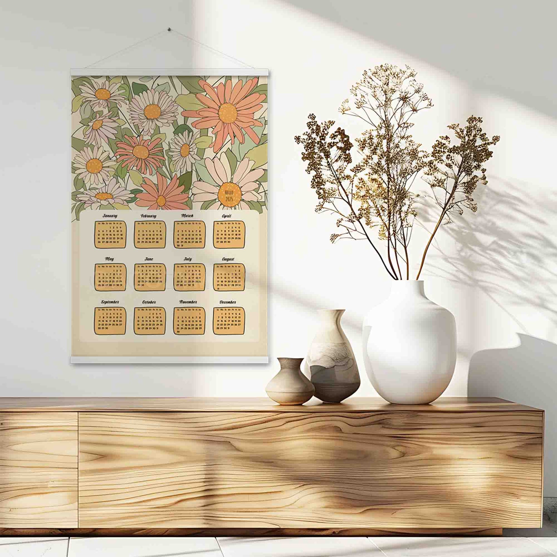 Illustrated 2025 calendar with flower art in beige, green, pink, and orange colors, featuring an white hanger. 