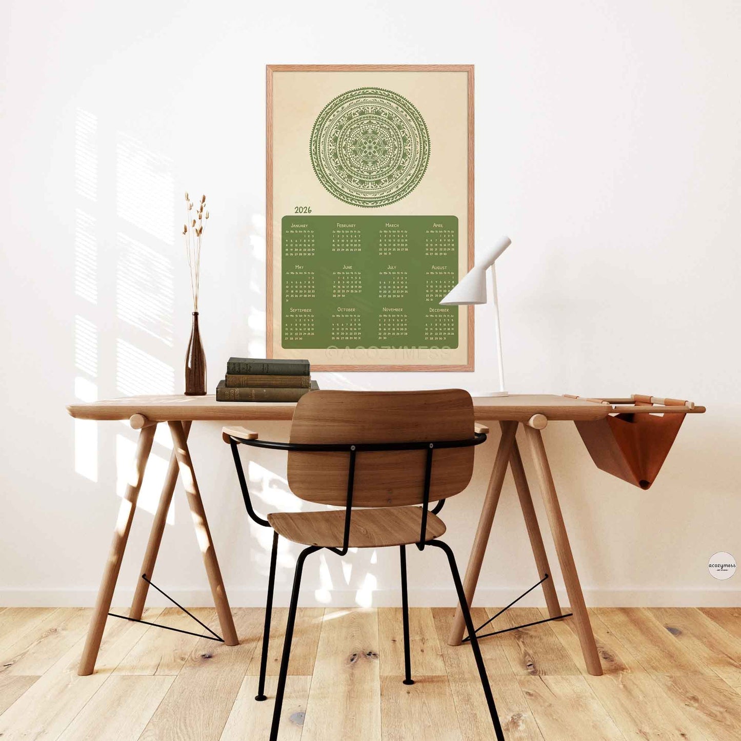  green calendar with mandala design on a beige background displayed in office on a desk wall