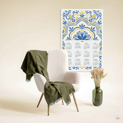 Decorative 2026 calendar with floral design on a wall displayed in white frame