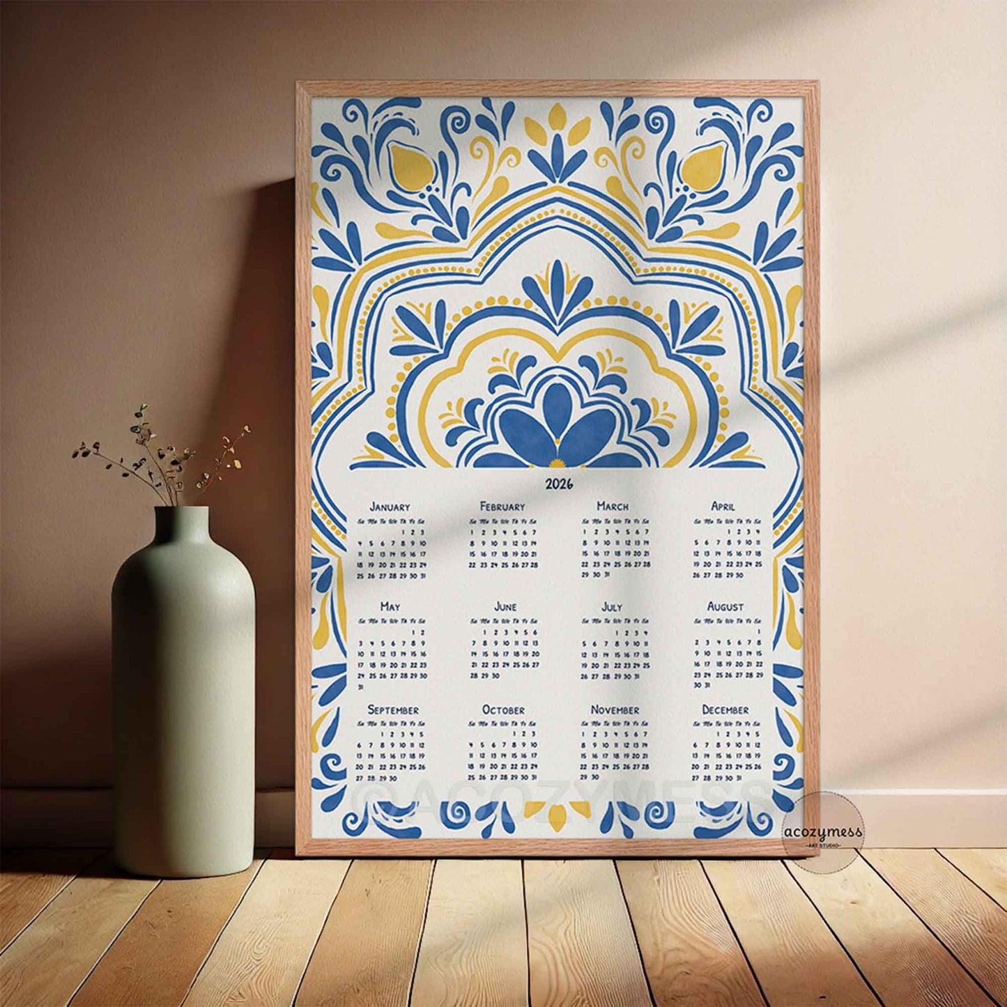 2026 wall calendar with geometric floral pattern, displayed in wooden frame.