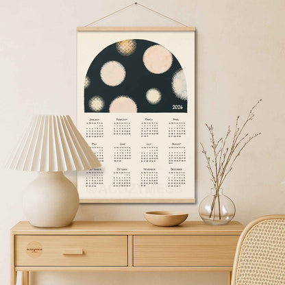 Framed calendar with abstract design on a wall above a wooden console table.