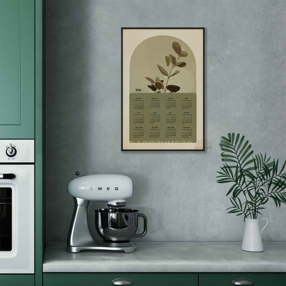 One page calendar 2026 with nature inspired art in green and beige in black frame displayed on a kitchen wall