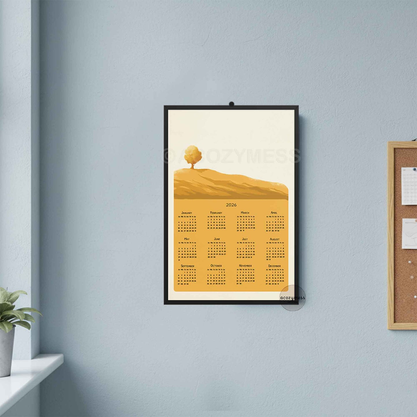 One page 2026 calendar with yellow landscape art displayed on a office wall