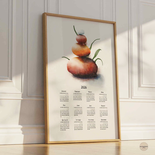 Framed artwork with a balancing stones and 2026 calendar on a wall.