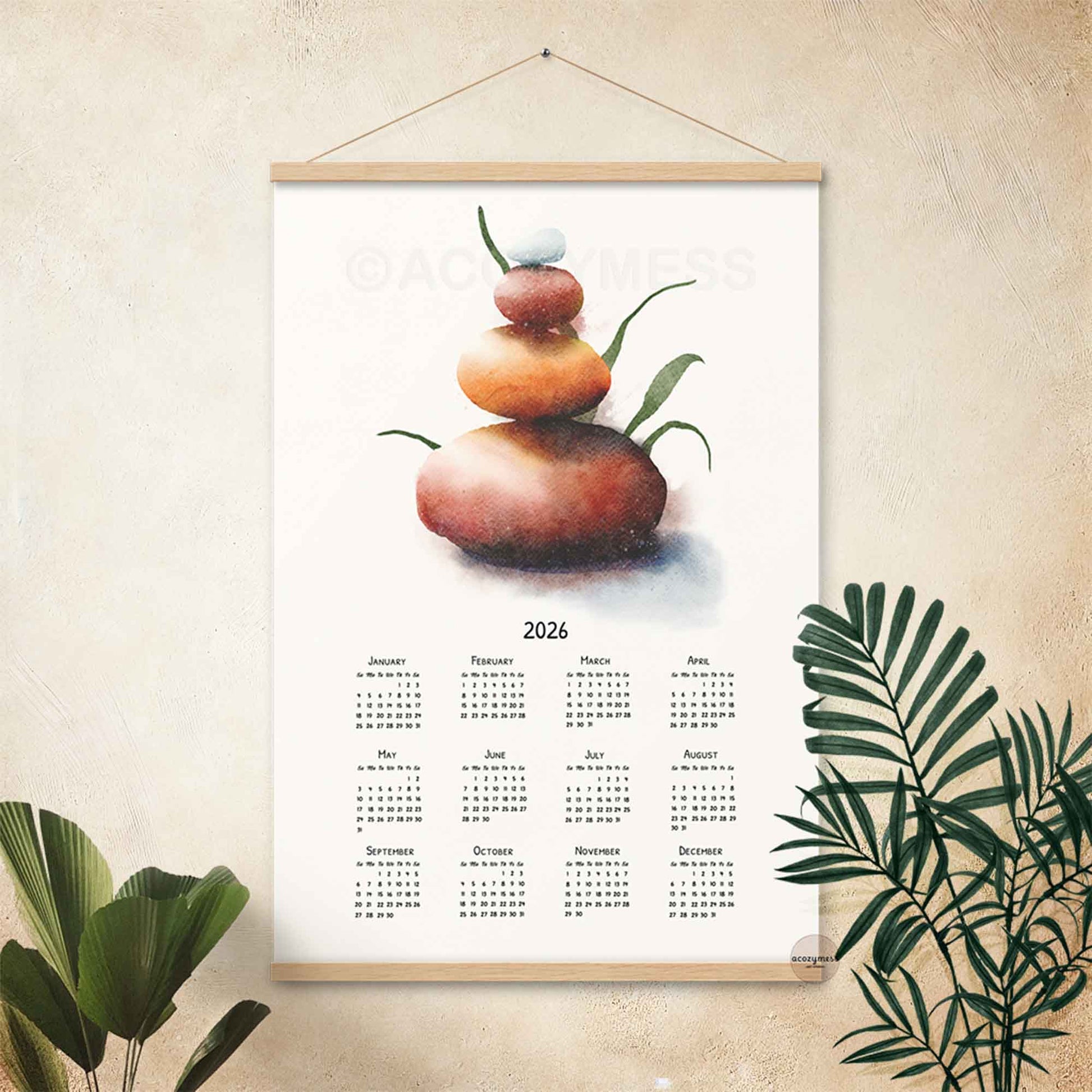 2026 calendar with balancing stones art hanging on a wall
