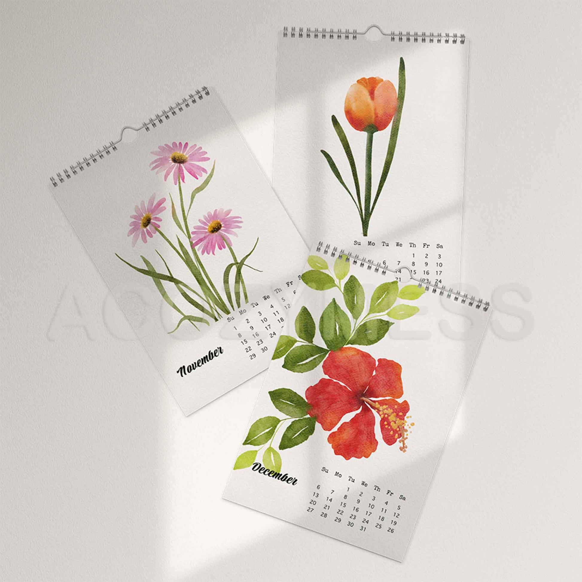 Three floral-themed wall calendars on a light gray background