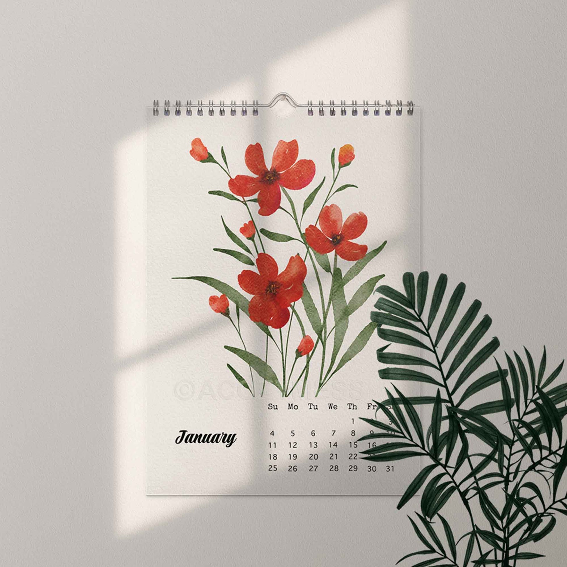 Wall calendar with red floral design on a light gray background