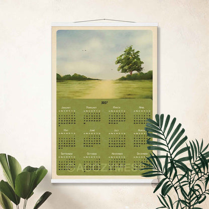 2027 landscape calendar print in a white hanger frame on a cream wall with tropical plants