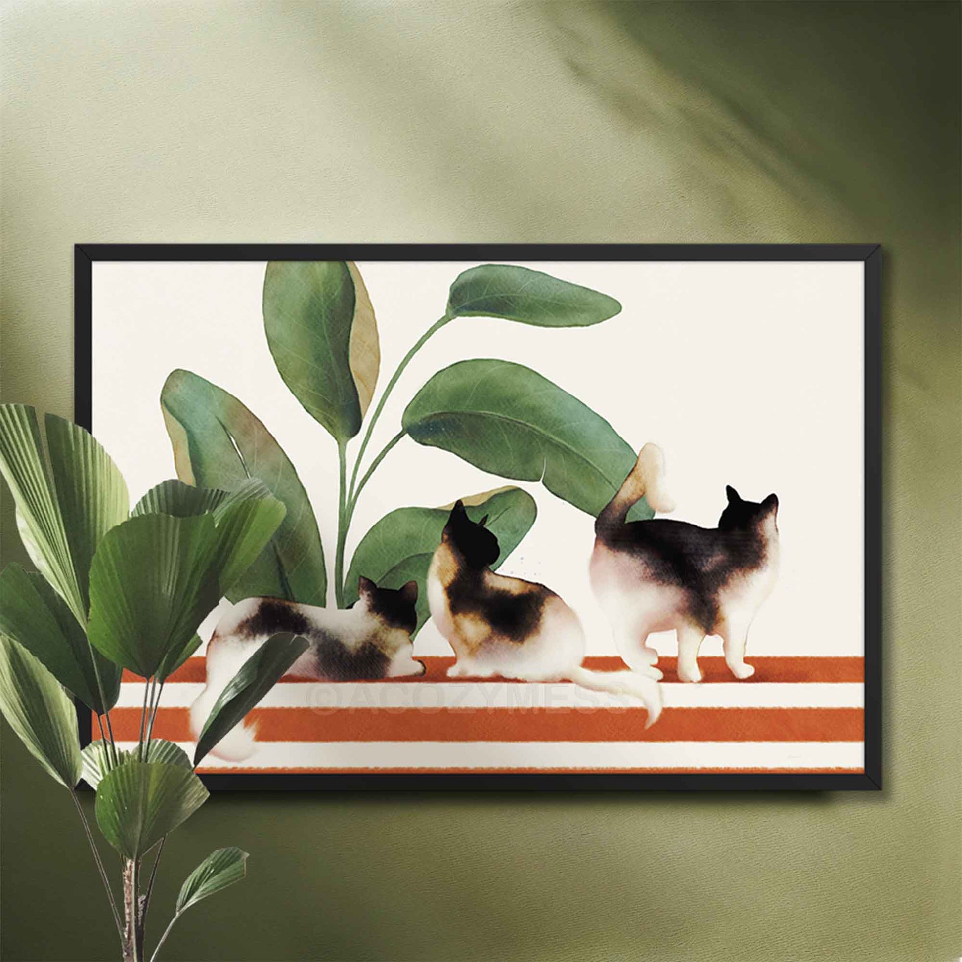 Black Framed artwork of three cats on a striped rug with plants art.