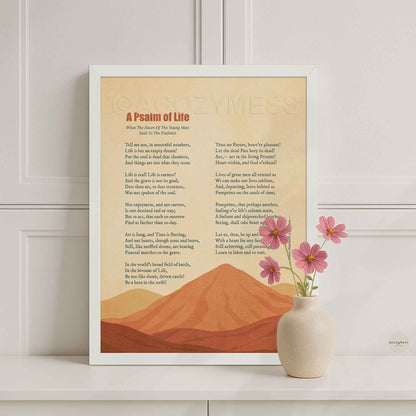 White framed Longfellow A Psalm of Life poetry poster on a white console with a pink flower vase in a bright room