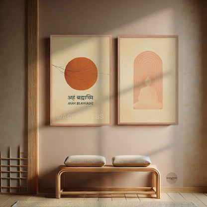 Two minimalist framed wall art prints hang above a wooden bench. The left print shows an orange sun with Devanagari text, and the right print shows a seated figure buddha inside peach arch lines.