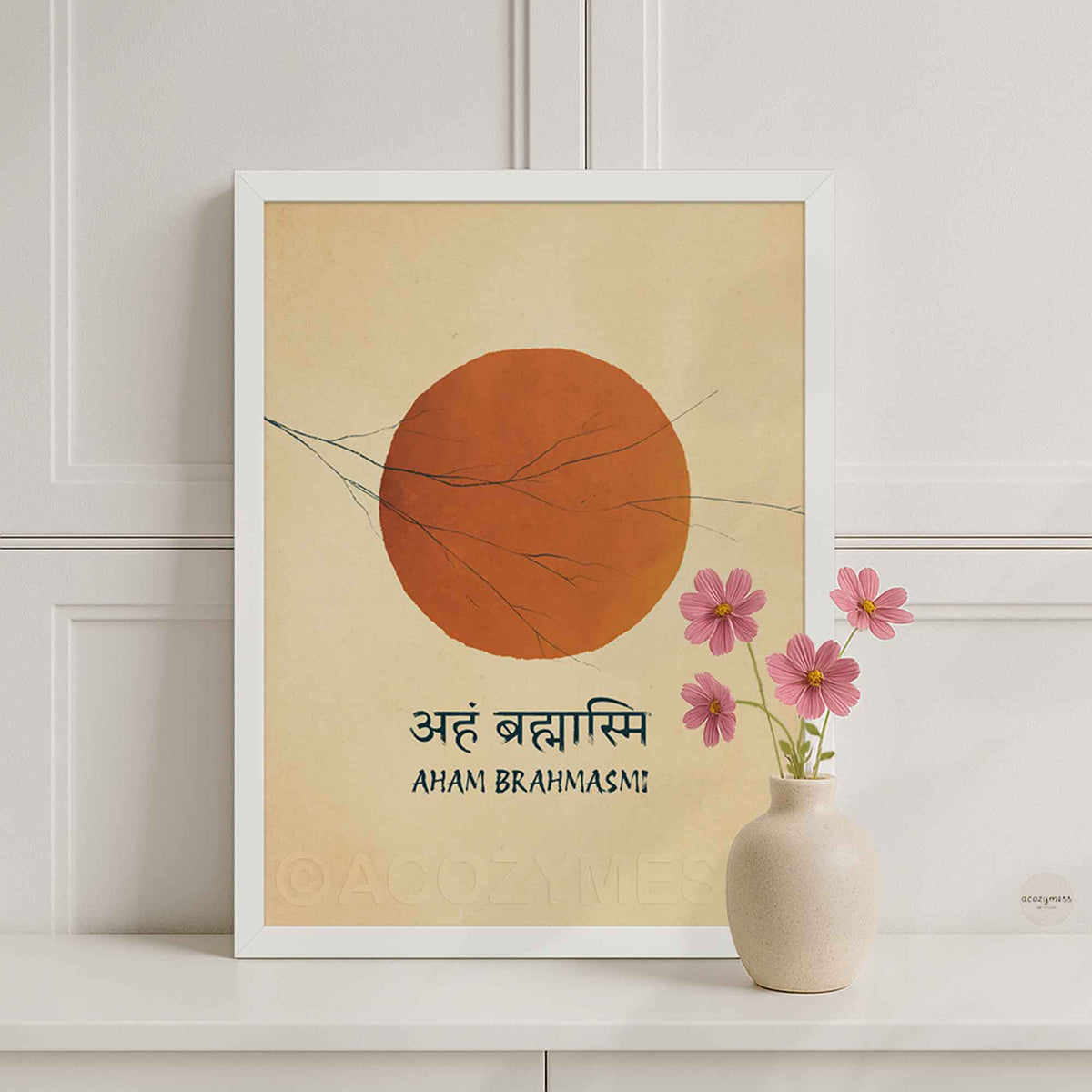 A white framed art print featuring a minimalist orange sun on a beige background with the Sanskrit and English text 'Aham Brahmasmi'.