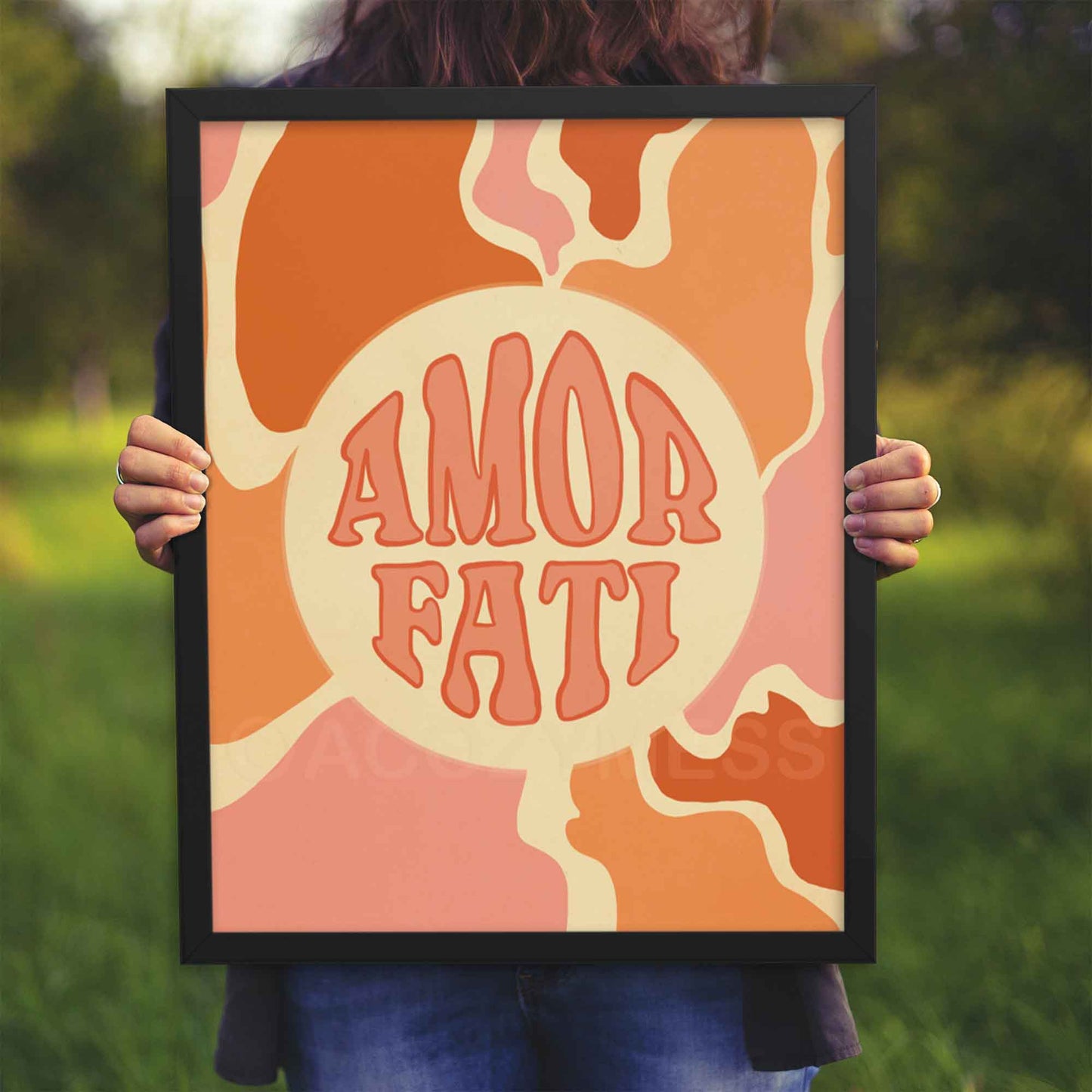 Amor Fati print with abstract art in soft pink, orange, and beige tones, symbolizing the Stoic philosophy of loving one's fate, displayed in a black frame.