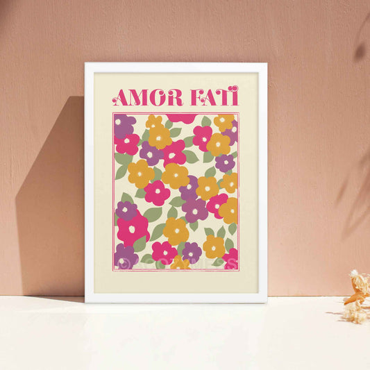 "Amor Fati Abstract Floral Design Art Poster featuring vibrant pink, purple, yellow, and green hues in an abstract floral arrangement on a light beige background, with the phrase 'Amor Fati' meaning 'love of one's fate' integrated into the design." in white frame