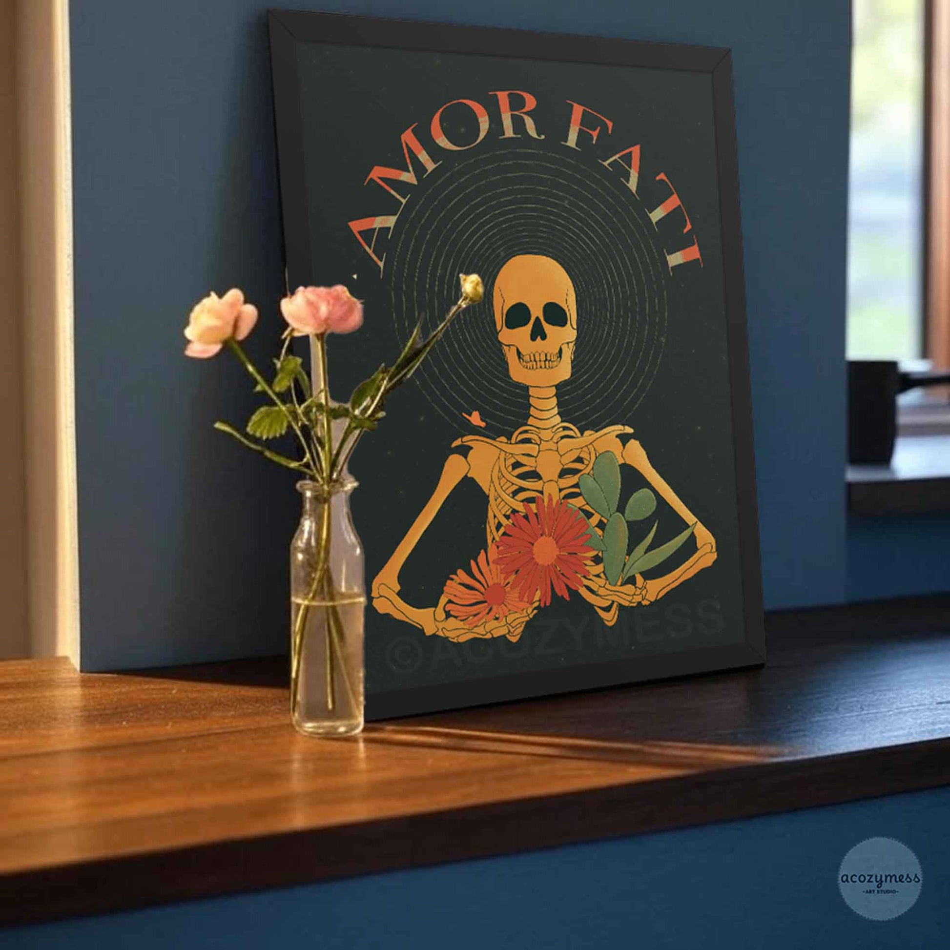 amor fati skeleton art print on dark background in black frame.