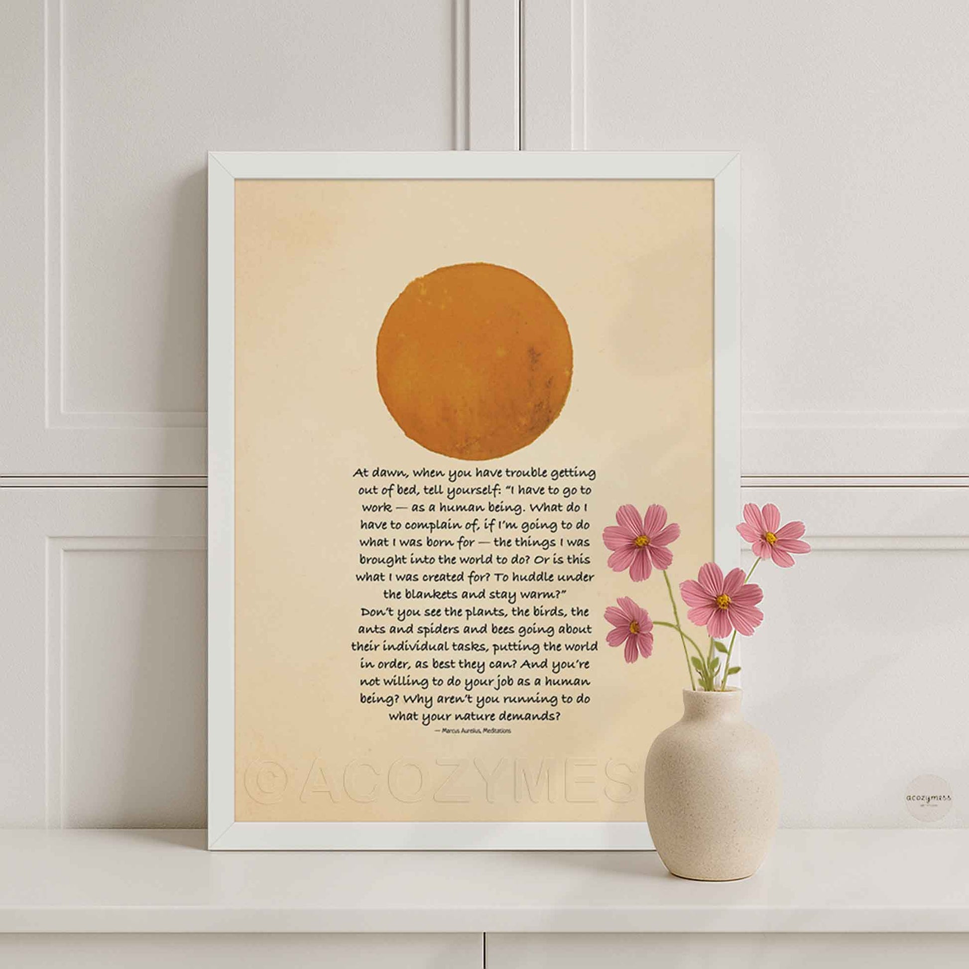 White Framed artwork with a sun illustration and stoic quote on a beige background.