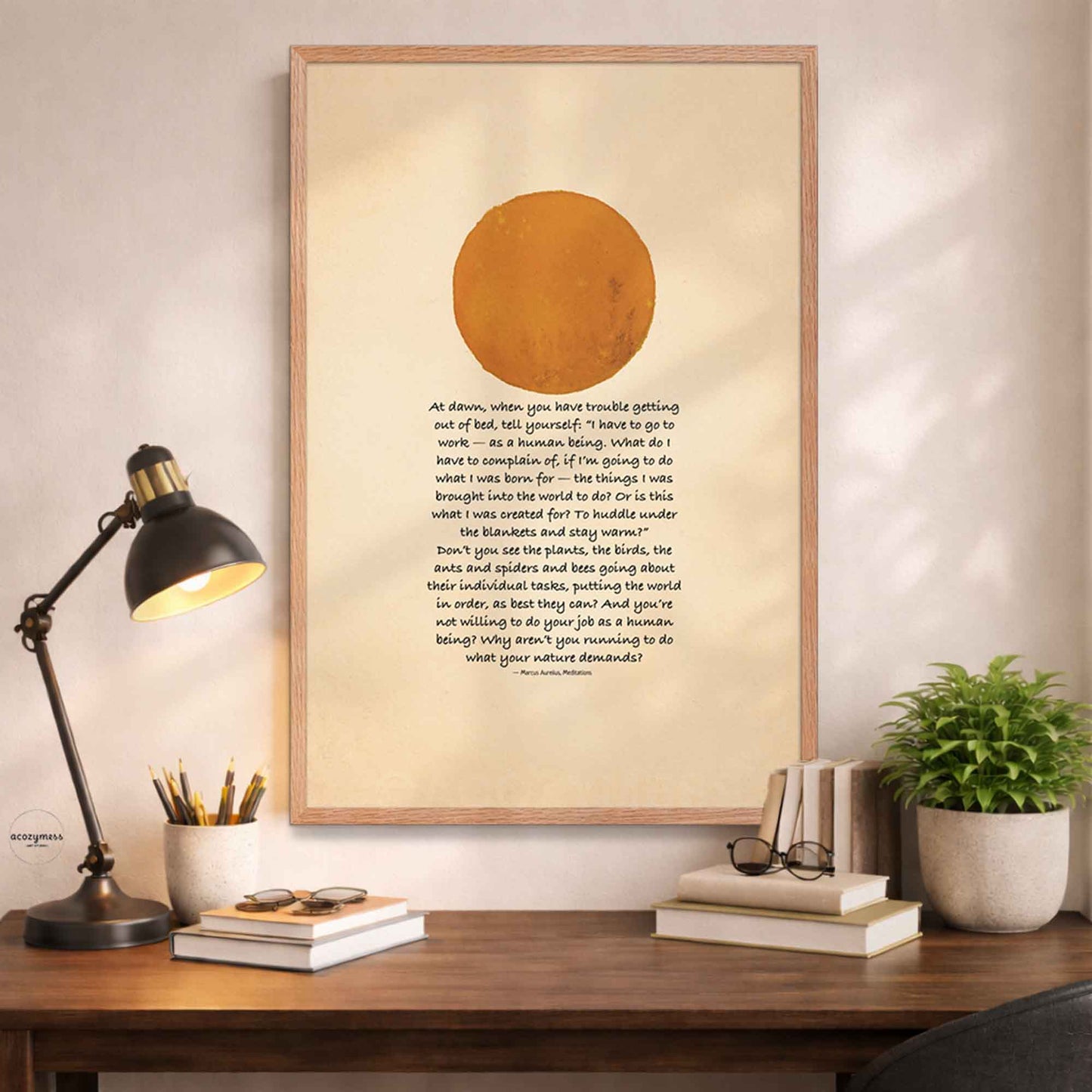 Oakwood Framed artwork with a Marcus Aurelius quote on a desk .