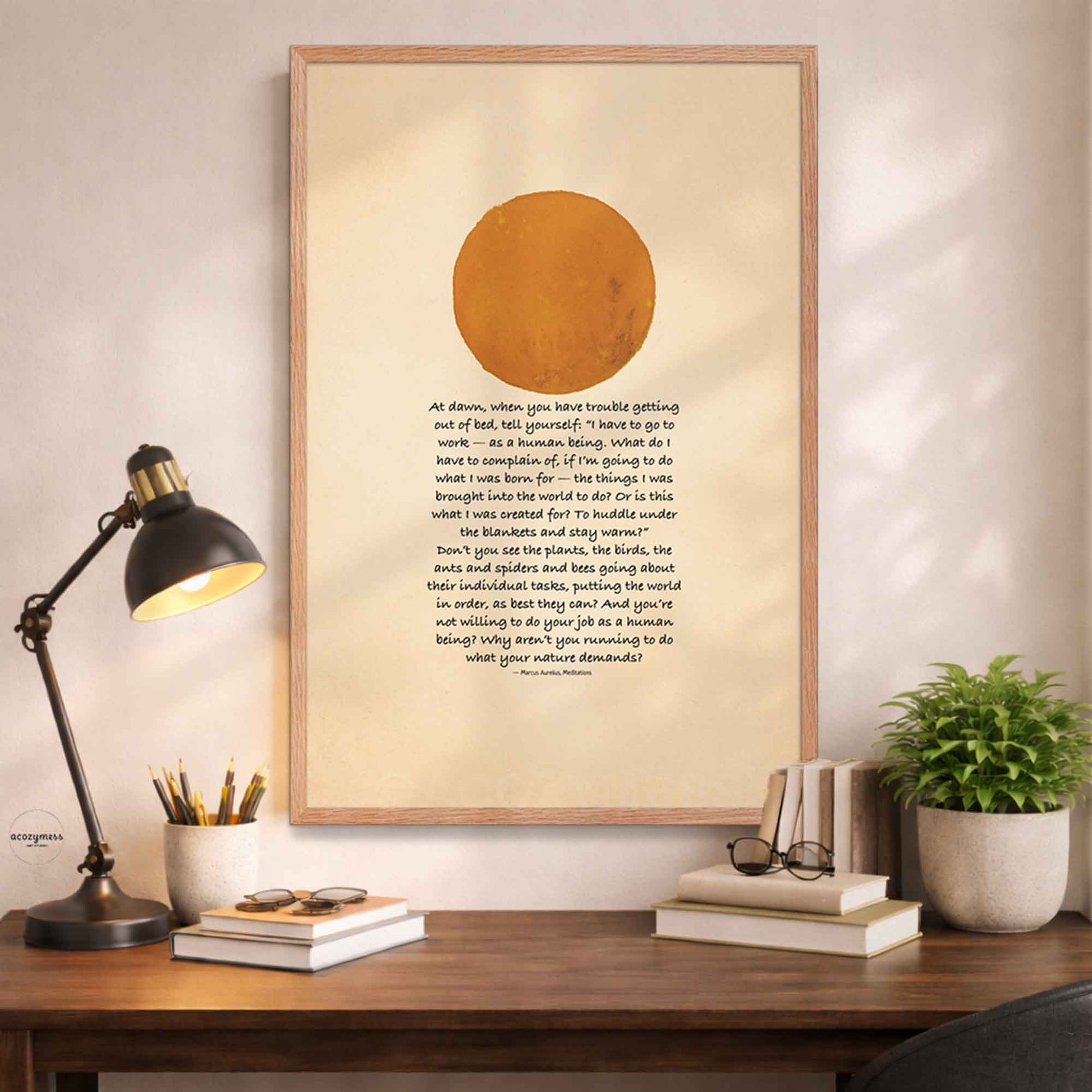 Oakwood Framed artwork with a Marcus Aurelius quote on a desk .