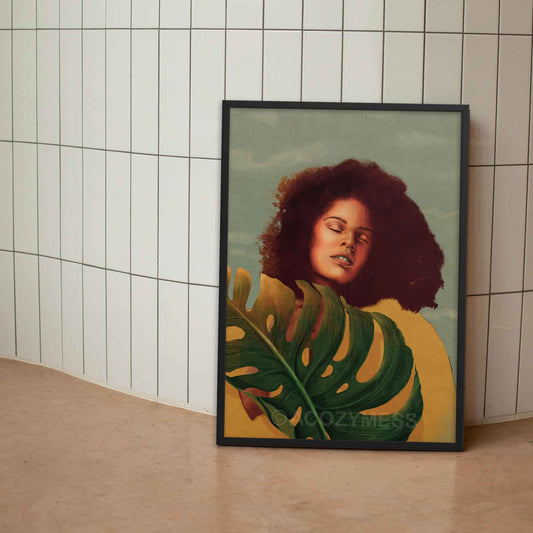 Black Woman Wall Art featuring a vibrant yellow background, confident pose, and monstera leaf in yellow, blue and green poster framed in black.